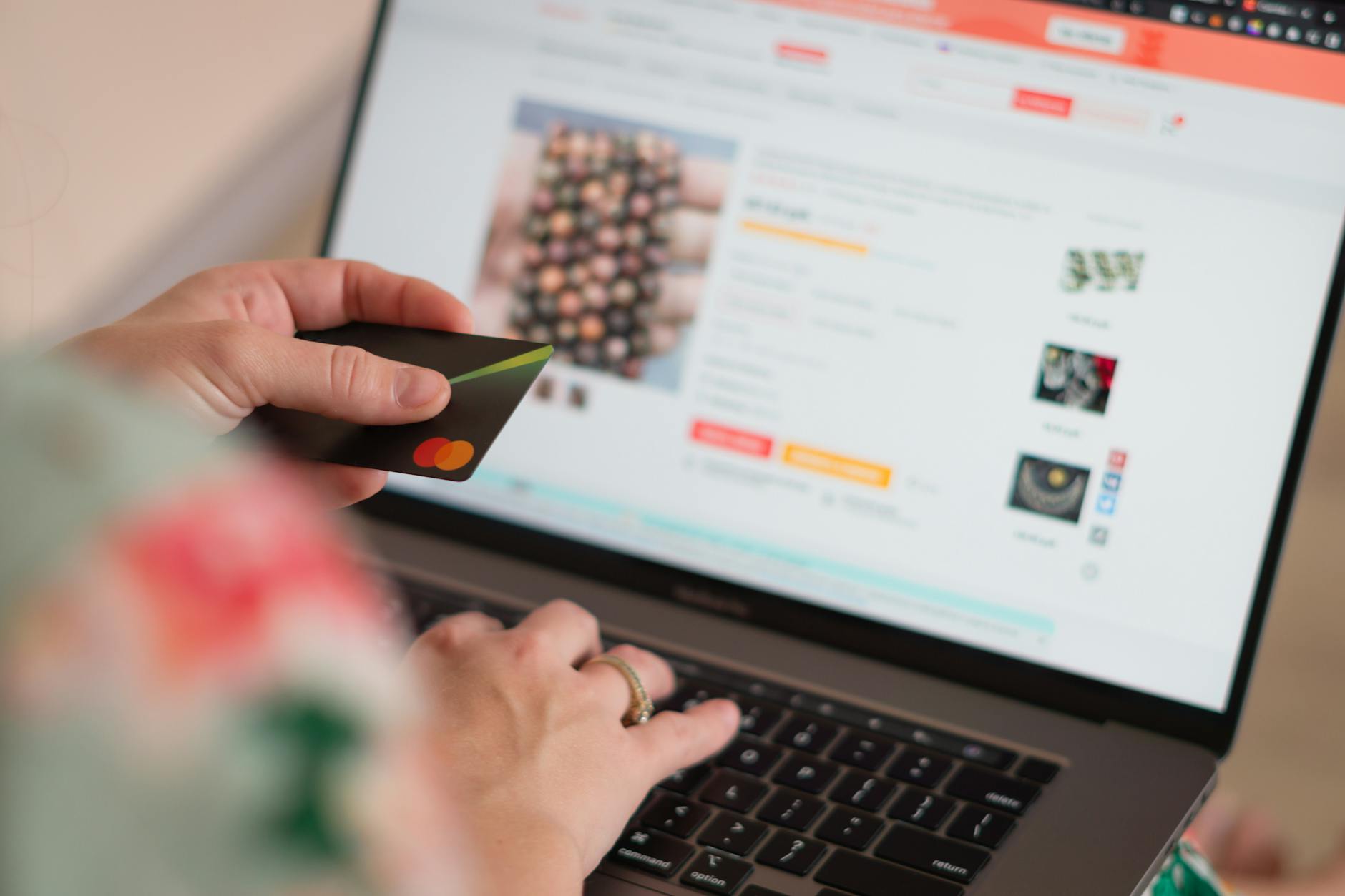 Osoba płaci kartą kredytową za zakupy w sklepie internetowym na laptopie